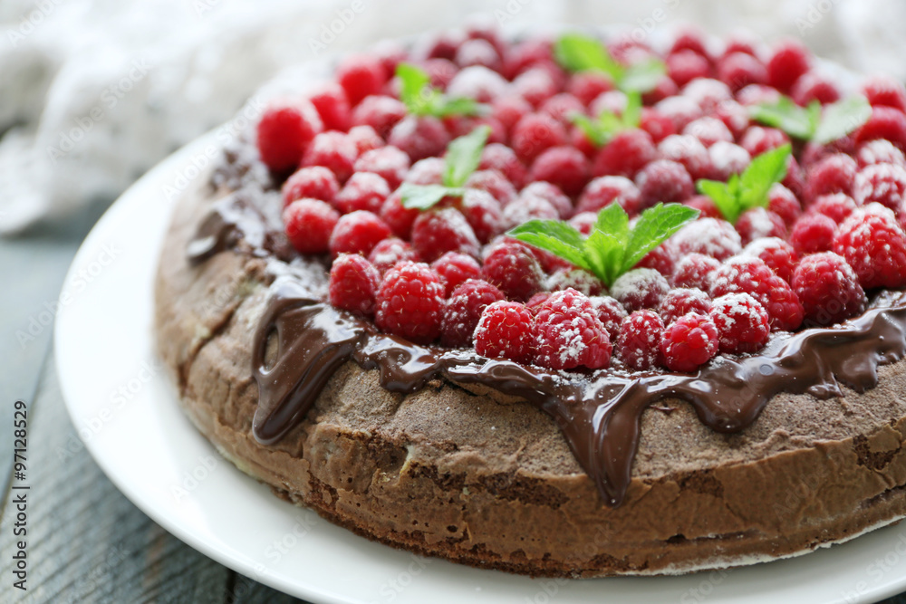 Cake with Chocolate Glaze and raspberries on wooden background Cake with Chocolate Glaze and raspberries on wooden background