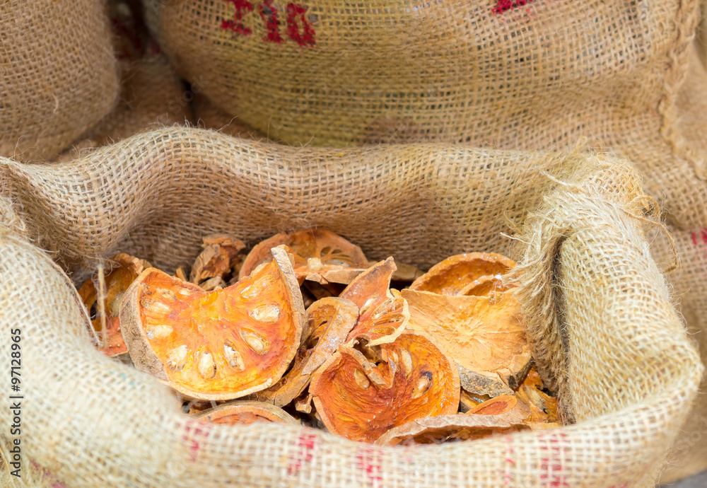 Fototapeta premium Aegle marmelos, dry herb on sack bag