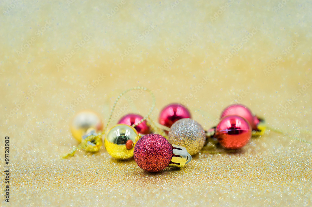 Christmas red and golden balls on golden background.