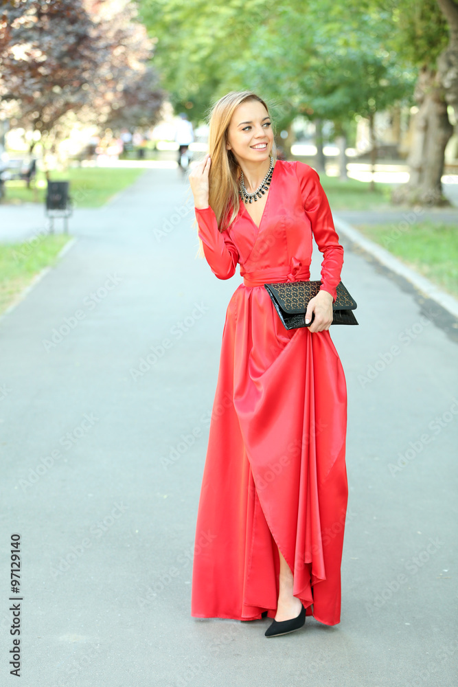 Beautiful young girl posing on city street