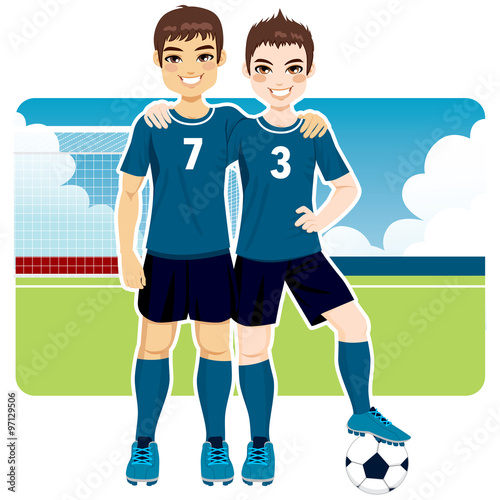 Two soccer team friends in uniform standing on field