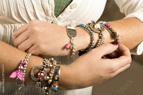 Woman adjusting bracelets closeup image