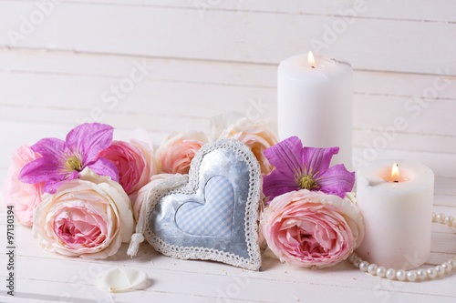 Decorative heart, pink roses  and violet clematis flowers , cand photo