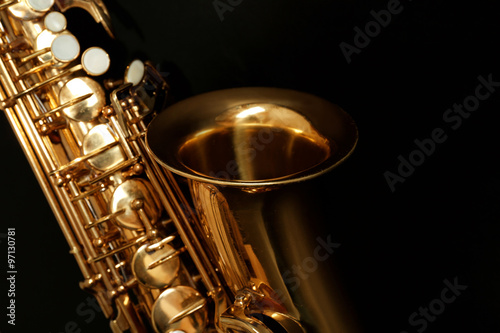 Fototapeta Beautiful golden saxophone on black background, close up