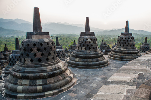 Stone stupa on the background of the surrounding landscape. Borobudur. Indonesia. The island of Java. An excellent illustration.