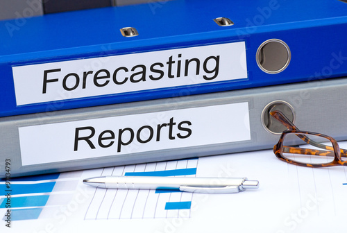 Forecasting and Reports - two binders with text on desk in the office
