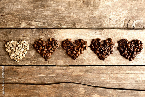 Collection of coffee beans on old wooden table, close up