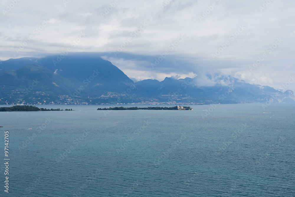 Lake Garda is the largest lake in Italy. It is located in Northern Italy, about half-way between Brescia and Verona, and between Venice and Milan.) Lake Garda is the largest lake in Italy. It is located in Northern Italy, about half-way between Brescia and Verona, and between Venice and Milan.)