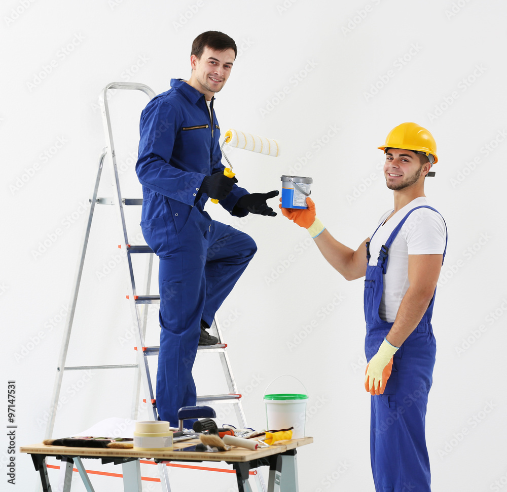 Workers renewing apartment on wall background Workers renewing apartment on wall background