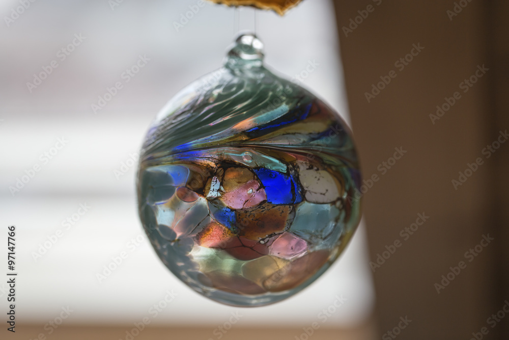 A colorful glass sphere in slight blur