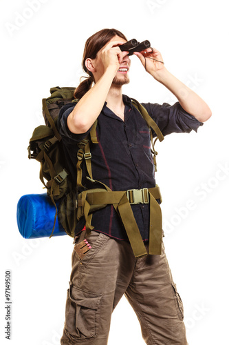 Man tourist backpacker looking through binoculars.