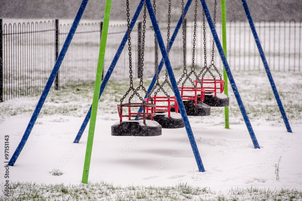Snow on swing seat in a children's playground Snow on swing seat in a children's playground