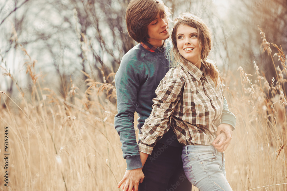 Fototapeta premium young happy loving couple walking on country field, cozy mood, rural scene