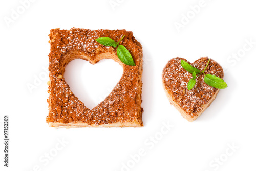 Heart shaped napoleon cake with mint on white background