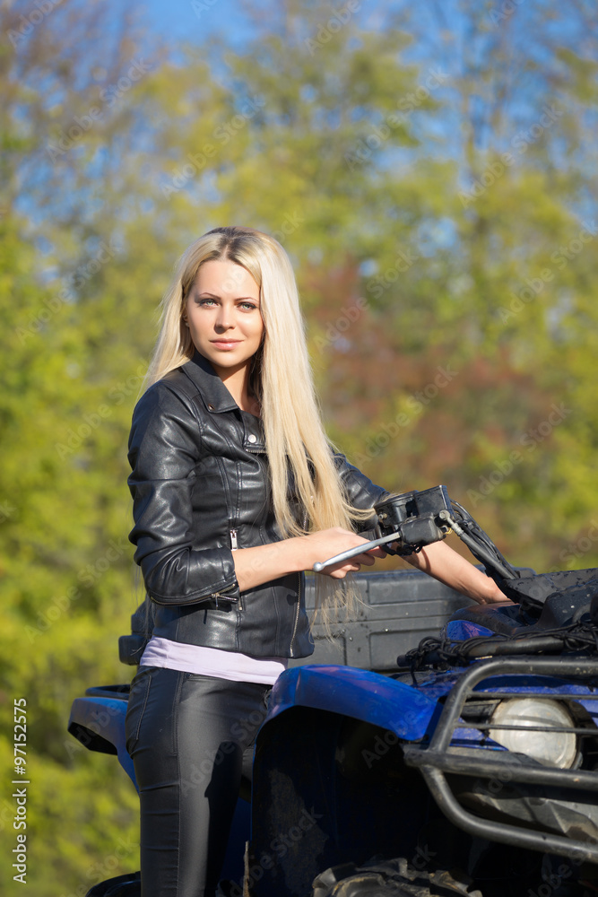 Elegant woman riding extreme quadrocycle ATV Elegant woman riding extreme quadrocycle ATV