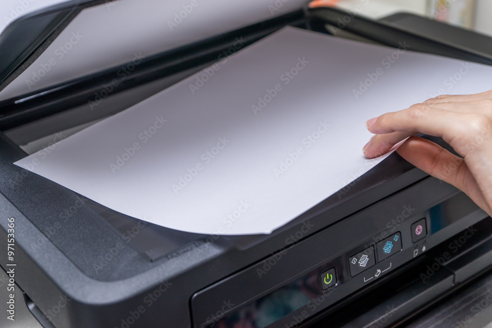 Close up Woman's hand with working copier, printer Close up Woman's hand with working copier, printer