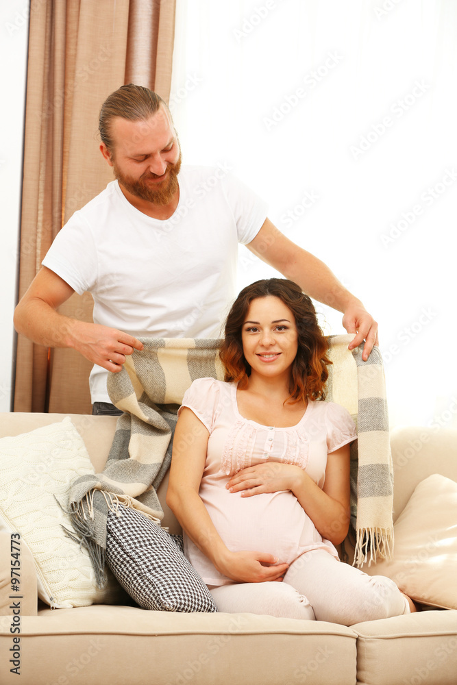 Handsome man takes care about his lovely pregnant woman Handsome man takes care about his lovely pregnant woman