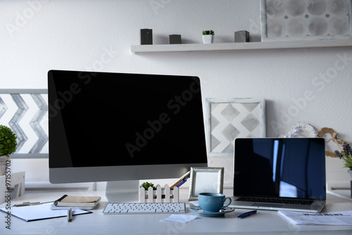 Workplace with computer and laptop on the table