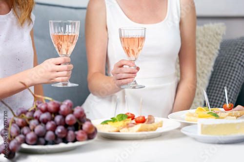 Friends hands with glasses of wine and snacks   close up