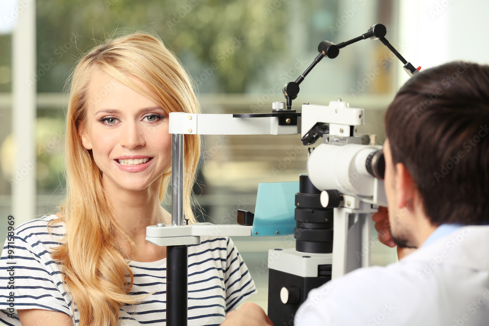 Adult male doctor examing adult female patient