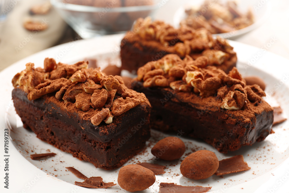 Pieces of chocolate cake with walnut on the table, close-up