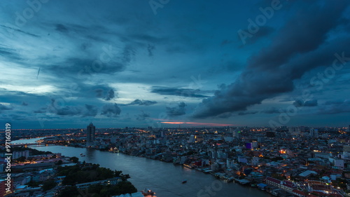 4K Timelapse day to night of Modern building in city with Chaophaya river at Bangkok, Thailand photo