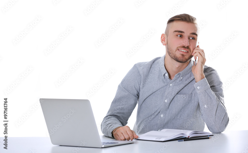 Businessman working with laptop on bright background Businessman working with laptop on bright background
