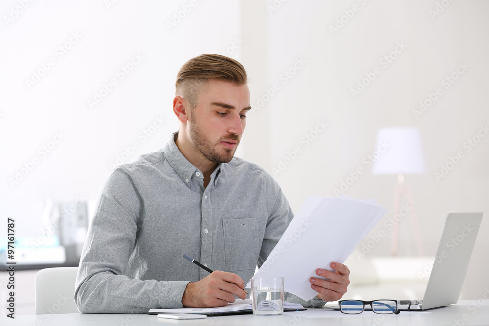 Businessman working with laptop in office Businessman working with laptop in office