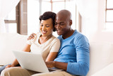 young african american couple using laptop computer