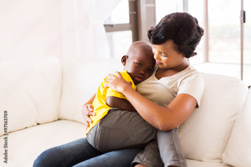 african american mother hugging her son - obrazy, fototapety, plakaty 