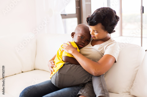 african american mother hugging her son © michaeljung