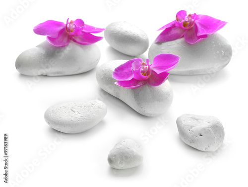 White spa stones and orchids isolated on white