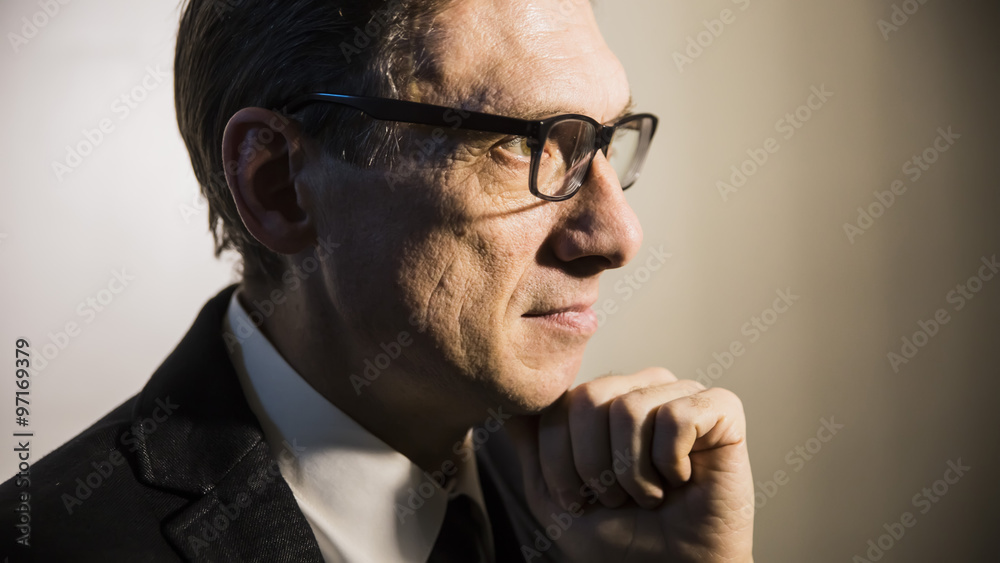 Fototapeta premium close portrait of an adult man in profile thinking in a dark room
