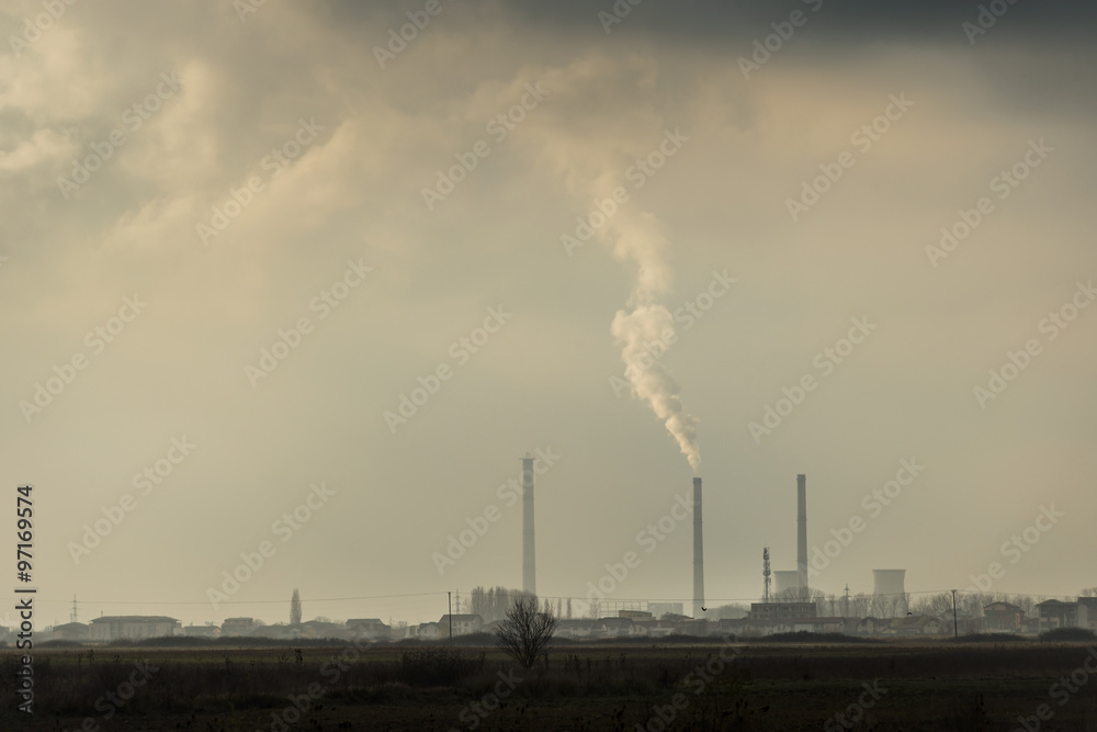 Industrial cityscape with coal power plant and smoke stacks