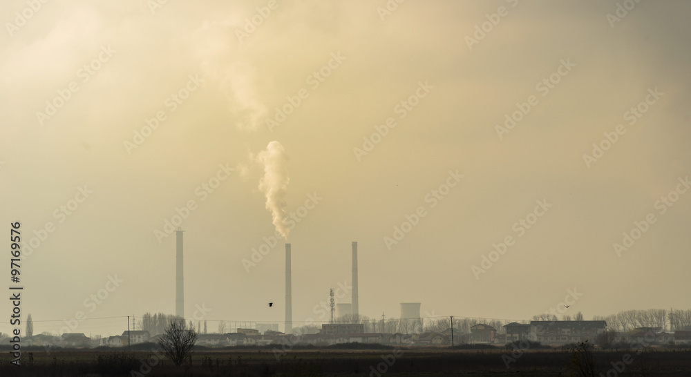 Industrial cityscape with coal power plant and smoke stacks