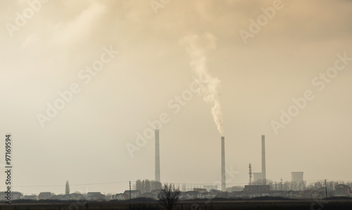 Industrial cityscape with coal power plant and smoke stacks