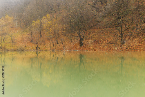 Reflection of autumn wood in lake.Village Vandam.Duyma.Gabala.Az