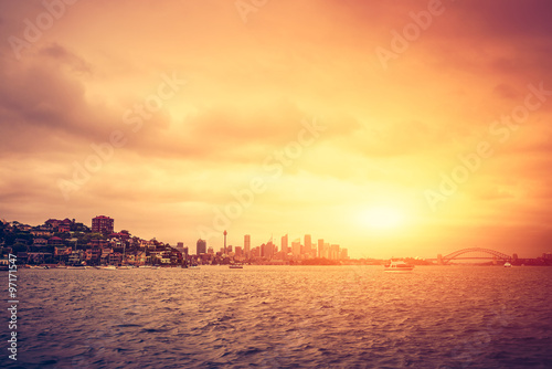 Sydney skyline at sunset with stormy clouds. Cross processing effect applied
