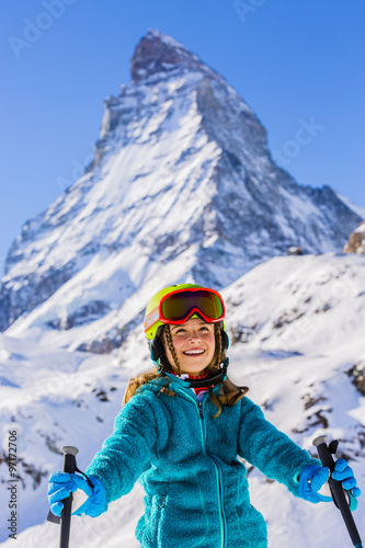Skier girl with view of Matterhorn on a clear sunny day - Zermatt, Switzerland 