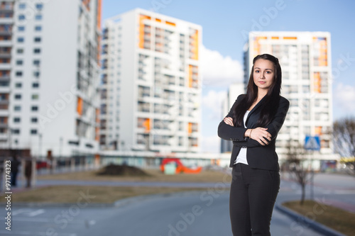 Businesswoman stands on the street photo