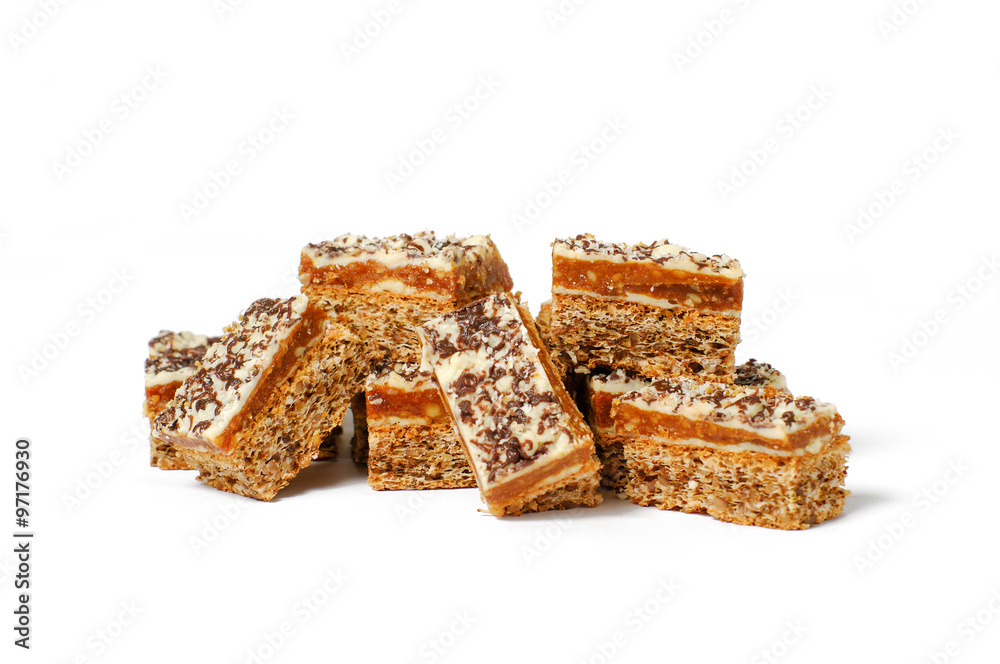 close-up of a group of eight pieces of delicious nutcakes, with white frosting and chocolate sprinkels ontop close-up of a group of eight pieces of delicious nutcakes, with white frosting and chocolate sprinkels ontop