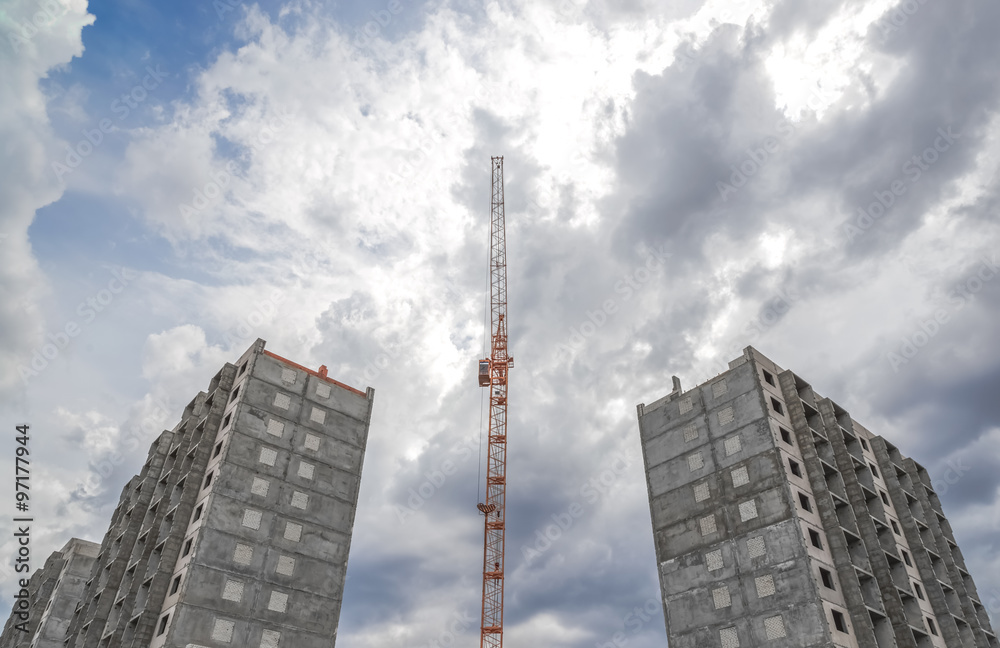 Fototapeta premium House construction and construction cranes
