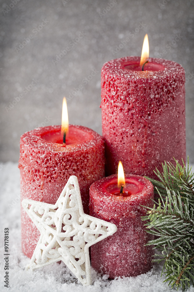 Three red candles on gray background, Christmas decoration. Adve Three red candles on gray background, Christmas decoration. Adve