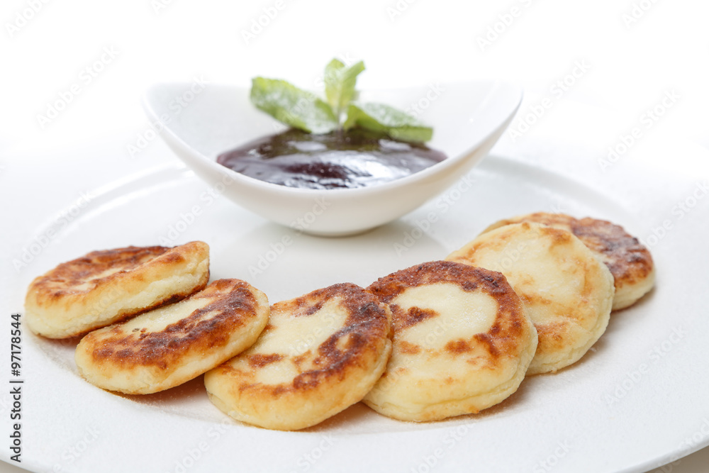 cheesecakes with jam on a plate in restaurant cheesecakes with jam on a plate in restaurant