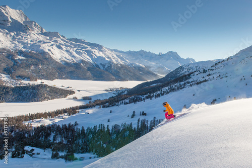 Girl telemark skier on the slope above the valley of lakes