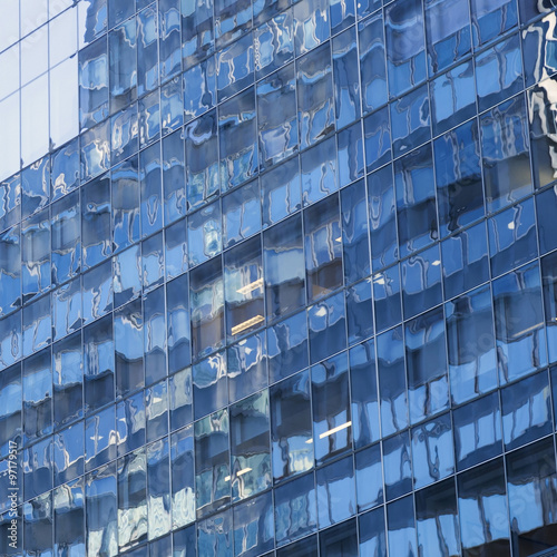 part of modern shiny blue facade of high rise building in new yo