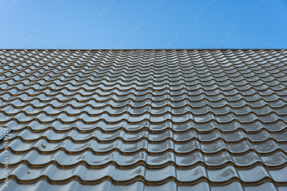 Metal tiles on a house`s roof Metal tiles on a house`s roof