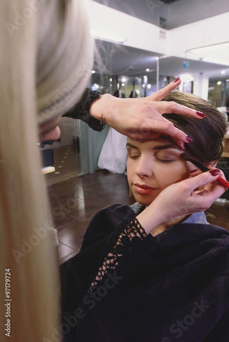 makeup artist preparing beautiful luxury stylish brunette bride