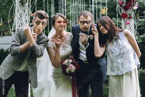 Valokuva elegant stylish happy guests and bride and groom having funny ph
