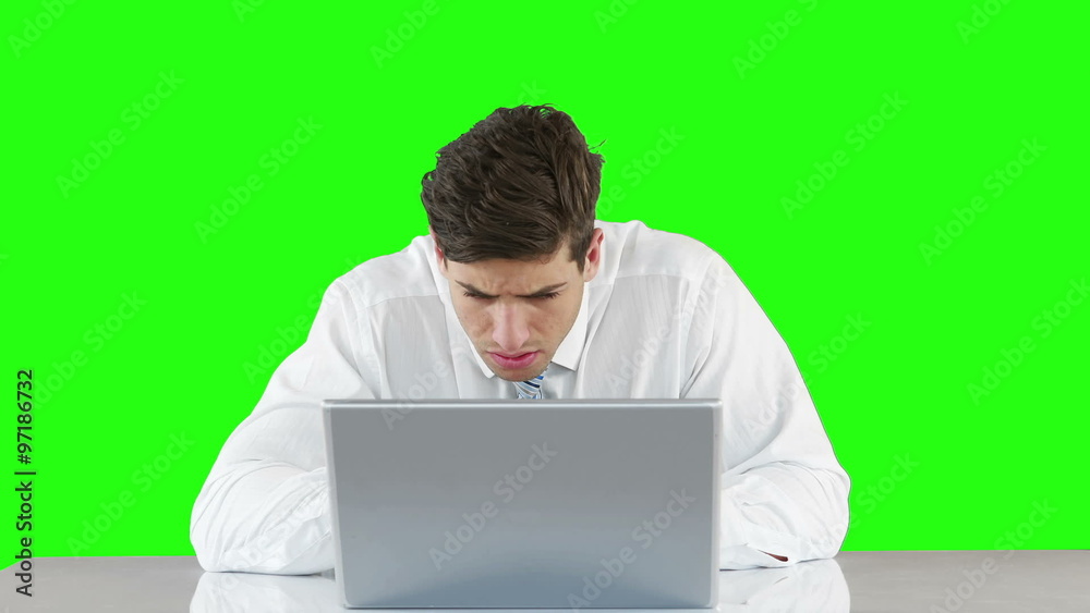 Worried businessman using laptop at desk Worried businessman using laptop at desk